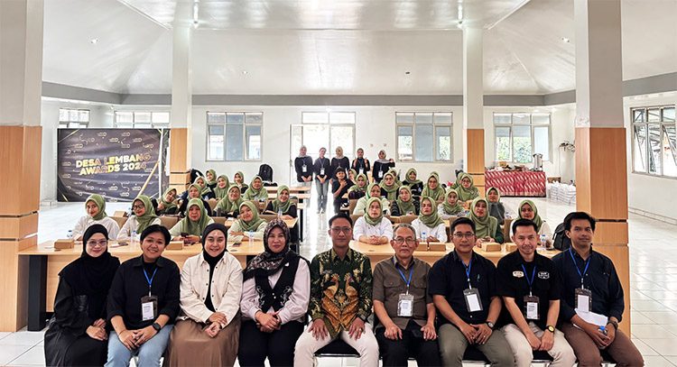 Tim PkM Unjani foto bersama dengan latar belakang para peserta Pelatihan Psychological First Aid (PFA) dan Kebencanaan - (Sumber: PMN)